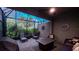 Relaxing screened patio with comfortable seating and a contemporary fire pit at 8732 Rain Song Rd, Sarasota, FL 34238