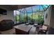 Well-appointed screened patio with comfortable lounge seating and tranquil views at 8732 Rain Song Rd, Sarasota, FL 34238
