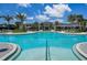 Resort-style pool with inviting blue water, ample lounge seating, and palm trees for relaxation and enjoyment at 8732 Rain Song Rd, Sarasota, FL 34238