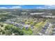 Community aerial view displaying a scenic neighborhood with lush landscaping and a tranquil lake at 9843 Cabernet Ave, Seffner, FL 33584