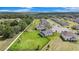 Drone image of a home with a sprawling backyard, solar panels, and a Gathering-friendly community at 9843 Cabernet Ave, Seffner, FL 33584