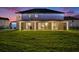 Backyard features a covered patio with lighting perfect for outdoor entertaining at 9843 Cabernet Ave, Seffner, FL 33584