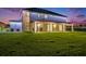 A large grassy backyard is adjacent to the home's covered outdoor living space at 9843 Cabernet Ave, Seffner, FL 33584