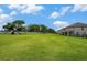Vast green backyard with a playset, fenced perimeter, and ample space for outdoor activities at 9843 Cabernet Ave, Seffner, FL 33584