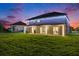 Expansive backyard with a covered patio, lush lawn, and privacy fence at 9843 Cabernet Ave, Seffner, FL 33584