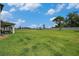 Large backyard with lush green grass, playground, and covered patio offering plenty of space for recreation and relaxation at 9843 Cabernet Ave, Seffner, FL 33584