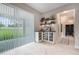 Entertaining bar area with custom cabinets, built-in wine racks and backyard view at 9843 Cabernet Ave, Seffner, FL 33584