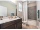 Bathroom with a white shower curtain, modern vanity, and stylish tile accents at 9843 Cabernet Ave, Seffner, FL 33584