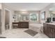 Luxurious bathroom featuring a soaking tub, marble tile, double vanity, and a makeup vanity at 9843 Cabernet Ave, Seffner, FL 33584
