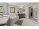 Bright bathroom showcasing a soaking tub with marble surround, modern vanity and walk in closet at 9843 Cabernet Ave, Seffner, FL 33584