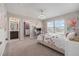 Well lit bedroom with plush carpet, decorative light fixture, and doorways to the bathroom and walk-in closet at 9843 Cabernet Ave, Seffner, FL 33584