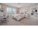 Bright bedroom featuring plush carpet, two windows, a study desk, and a view into the connected dining room at 9843 Cabernet Ave, Seffner, FL 33584
