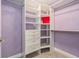 Walk-in closet with custom shelving and drawers, offering ample storage space at 9843 Cabernet Ave, Seffner, FL 33584