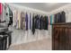 Walk-in closet featuring ample hanging space, wire shelving, and dark wood cabinets at 9843 Cabernet Ave, Seffner, FL 33584