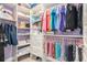 Well-organized walk-in closet featuring built-in shelving, drawers, and ample hanging space for clothes and accessories at 9843 Cabernet Ave, Seffner, FL 33584