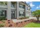 Close-up of a two-story home featuring a beautiful front door, elegant landscaping, and a three-car garage at 9843 Cabernet Ave, Seffner, FL 33584