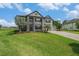 Beautiful two-story home with well-manicured lawn, palm trees, and a brick-paved driveway leading to the garage at 9843 Cabernet Ave, Seffner, FL 33584