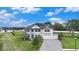 Two-story home with a manicured lawn, solar panels, 3-car garage and a paved driveway at 9843 Cabernet Ave, Seffner, FL 33584