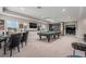 Spacious game room featuring a pool table, custom cabinets and beverage center, and ample space for entertaining at 9843 Cabernet Ave, Seffner, FL 33584
