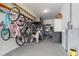 Bright garage featuring plenty of storage, a Tesla charger, and mounted bike rack for active lifestyles at 9843 Cabernet Ave, Seffner, FL 33584