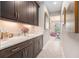 Hallway with dark wood cabinets and a marble countertop at 9843 Cabernet Ave, Seffner, FL 33584