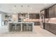 Open kitchen with island seating, stainless appliances, and custom cabinetry at 9843 Cabernet Ave, Seffner, FL 33584