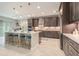 Bright, open kitchen with island seating, stainless steel appliances, and custom cabinets at 9843 Cabernet Ave, Seffner, FL 33584