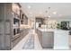 Modern kitchen features stainless steel appliances, large island, and custom cabinets at 9843 Cabernet Ave, Seffner, FL 33584