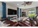 Inviting living room boasts a cozy fireplace, modern furnishings, and a view of the backyard at 9843 Cabernet Ave, Seffner, FL 33584