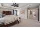 Bright main bedroom with dark wood furniture, tray ceiling, carpet flooring, and ensuite bathroom access at 9843 Cabernet Ave, Seffner, FL 33584