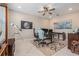 Bright office area featuring custom rug, work stations, and unique ceiling fan at 9843 Cabernet Ave, Seffner, FL 33584