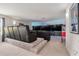 Home theater room with tiered seating, multiple large screen TVs, a popcorn machine, and custom ambient lighting at 9843 Cabernet Ave, Seffner, FL 33584