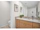Stylish bathroom featuring a granite countertop, wood cabinets, decorative artwork, and a neutral color palette at 100 4Th S Ave # 132, St Petersburg, FL 33701
