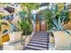 Inviting front entrance with tiled stairs, lush tropical foliage, and charming architectural details at 100 4Th S Ave # 132, St Petersburg, FL 33701