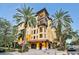Beautiful condominium complex featuring Mediterranean architecture, lush landscaping, and vibrant color palette at 100 4Th S Ave # 132, St Petersburg, FL 33701
