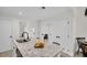 Open kitchen featuring a center island with seating, white cabinets, and modern fixtures at 100 4Th S Ave # 132, St Petersburg, FL 33701