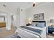 Comfortable main bedroom with ceiling fan, carpet and two matching bedside tables at 100 4Th S Ave # 132, St Petersburg, FL 33701