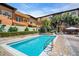 A tranquil pool area surrounded by lush landscaping and outdoor seating at 100 4Th S Ave # 132, St Petersburg, FL 33701