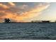 Tranquil waterfront view featuring buildings and piers silhouetted against a vibrant sunset sky at 100 4Th S Ave # 132, St Petersburg, FL 33701