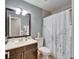 Bathroom with a white paris-themed shower curtain and dark vanity at 10717 Drummond Rd, Tampa, FL 33615