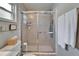Bathroom with a glass shower door and white towels on a rack to the right of the shower at 10717 Drummond Rd, Tampa, FL 33615
