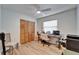 Bedroom with wood floors, a ceiling fan, a window and a closet with louvered doors at 10717 Drummond Rd, Tampa, FL 33615
