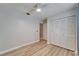 Bedroom with a closet with louvered doors, ceiling fan and hardwood floors at 10717 Drummond Rd, Tampa, FL 33615