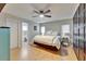 Serene main bedroom with a large bed, ceiling fan, wood floors, and a private bathroom at 10717 Drummond Rd, Tampa, FL 33615