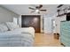 Spacious main bedroom featuring a ceiling fan, closet, and wood flooring at 10717 Drummond Rd, Tampa, FL 33615