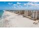 Stunning aerial view of beachfront condos and the shoreline with white sand and clear blue skies at 11 San Marco St # 407, Clearwater Beach, FL 33767