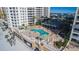 Beautiful overhead shot of a resort-style pool area with palm trees between luxury beachfront condos at 11 San Marco St # 407, Clearwater Beach, FL 33767