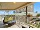 Charming balcony with comfortable seating and views of palm trees and nearby buildings at 11 San Marco St # 407, Clearwater Beach, FL 33767