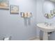 Bathroom featuring neutral paint, a pedestal sink, and decorative artwork at 11 San Marco St # 407, Clearwater Beach, FL 33767