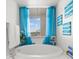 Bathroom featuring a bathtub, bright window, and vanity at 11 San Marco St # 407, Clearwater Beach, FL 33767